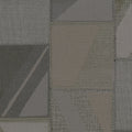 Textured fabric pattern with geometric shapes in shades of gray and brown.
