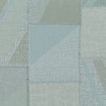 Textured fabric with a patchwork pattern in shades of green and gray.
